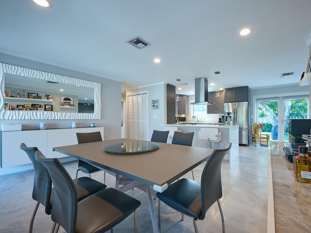 dining room with sink and crown molding