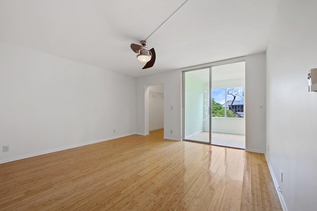 spare room featuring light wood-type flooring and ceiling fan