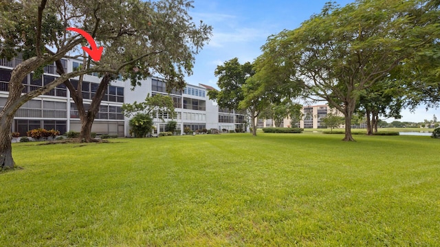 view of home's community featuring a yard and a water view