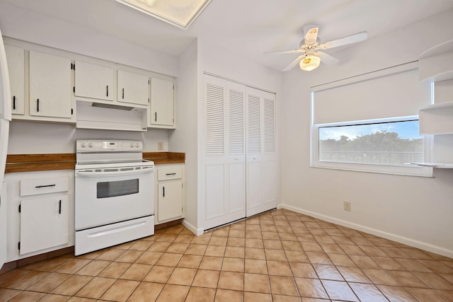 kitchen featuring electric range, light tile patterned flooring, white cabinets, and ceiling fan