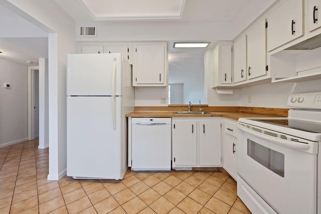 kitchen featuring sink, white cabinets, white appliances, and light tile patterned flooring