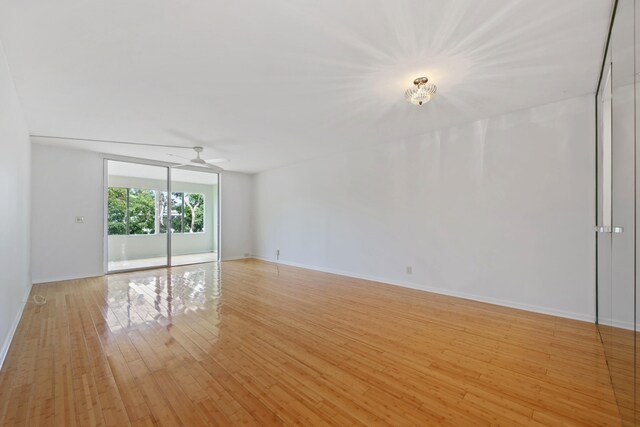 empty room with light wood-type flooring and ceiling fan