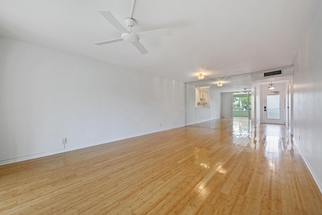 unfurnished room featuring light hardwood / wood-style flooring and ceiling fan