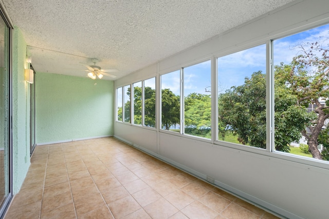 unfurnished sunroom featuring ceiling fan