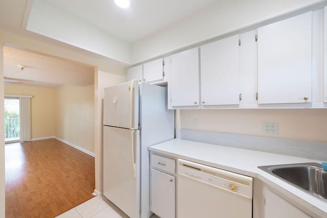 kitchen with light hardwood / wood-style flooring, sink, white appliances, and white cabinetry