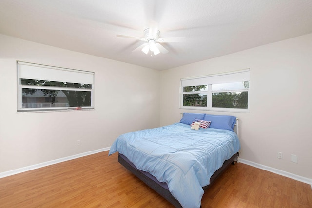 bedroom with hardwood / wood-style floors and ceiling fan