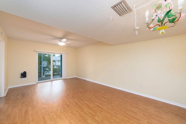 unfurnished living room featuring light wood-type flooring, a textured ceiling, and ceiling fan