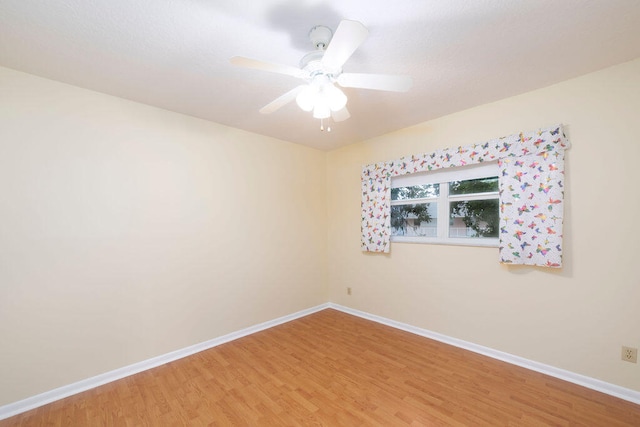 spare room with ceiling fan and hardwood / wood-style flooring