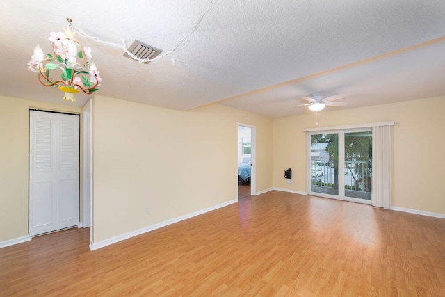 unfurnished room featuring ceiling fan, a textured ceiling, and light hardwood / wood-style flooring