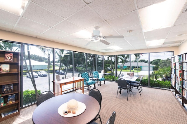 sunroom / solarium featuring ceiling fan and a paneled ceiling