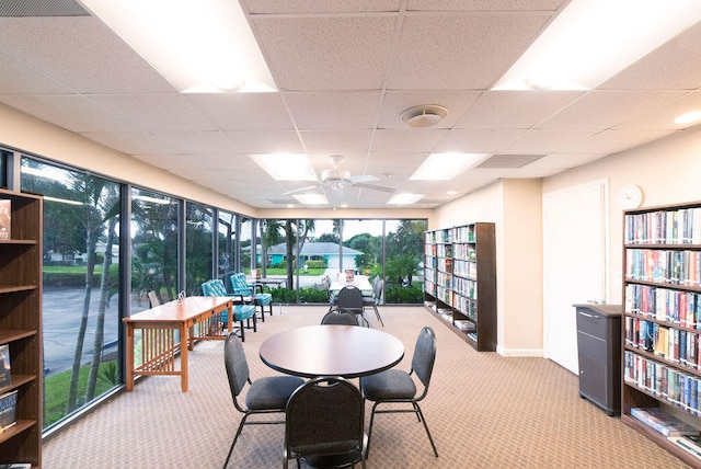 interior space featuring a drop ceiling and ceiling fan