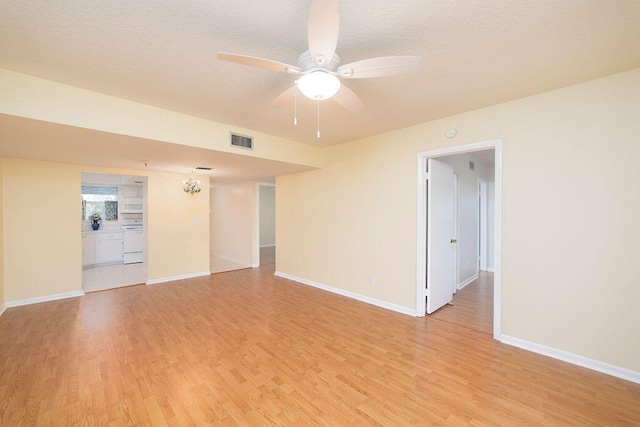 unfurnished room with ceiling fan, a textured ceiling, and light hardwood / wood-style floors