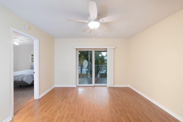 empty room with ceiling fan and light wood-type flooring