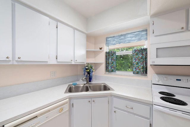 kitchen with sink, white appliances, and white cabinetry