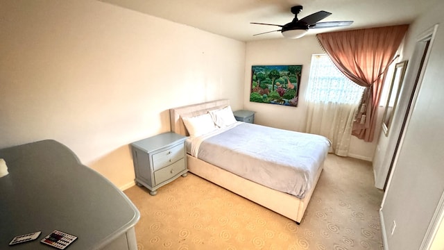 bedroom with ceiling fan and light colored carpet