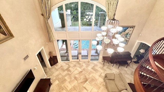 interior space featuring french doors and an inviting chandelier