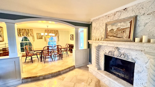 interior space featuring decorative columns, a premium fireplace, a notable chandelier, and ornamental molding