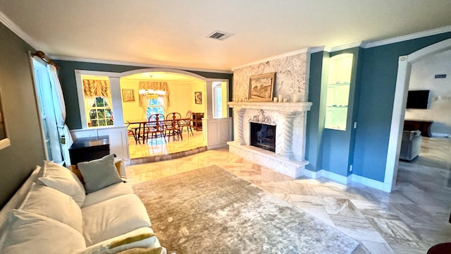 living room featuring a high end fireplace, a notable chandelier, and ornamental molding