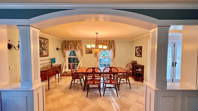 dining space featuring a chandelier, decorative columns, and ornamental molding