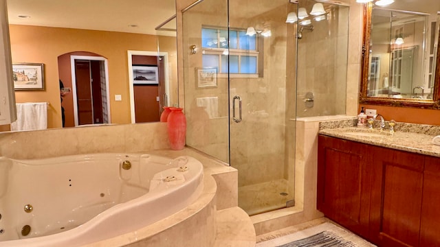 bathroom with separate shower and tub and vanity