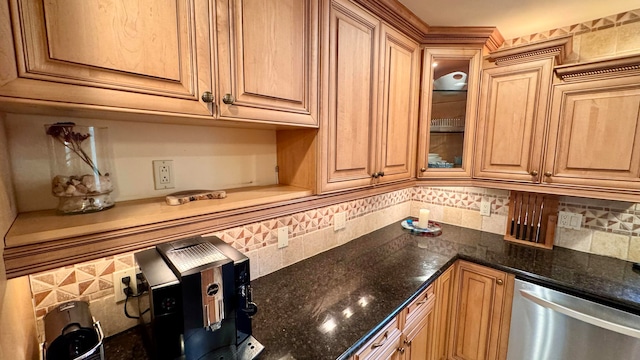 kitchen featuring dishwasher, decorative backsplash, and dark stone counters