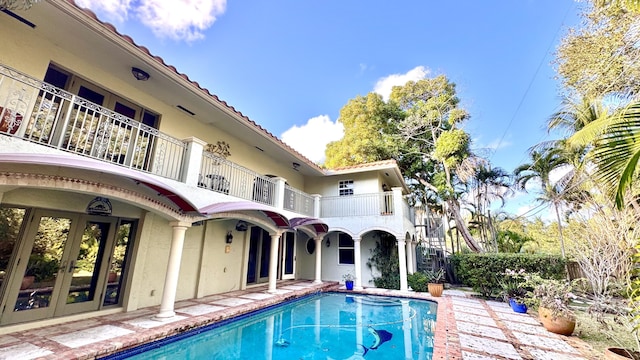 view of pool featuring french doors and a patio