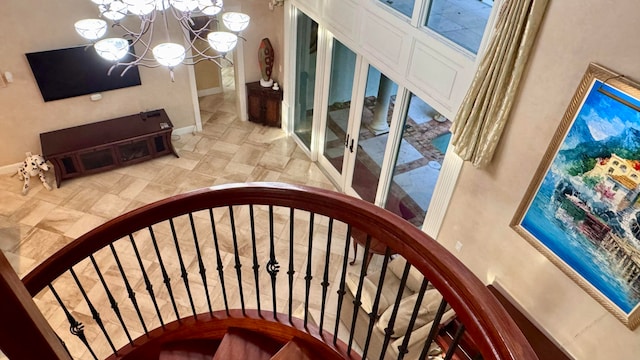 staircase with a chandelier