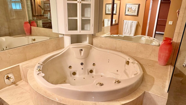 bathroom featuring tile patterned flooring and tiled tub