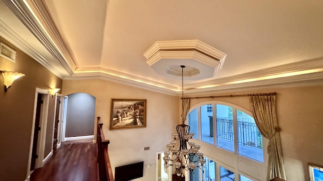 interior details featuring hardwood / wood-style flooring, a raised ceiling, and ornamental molding