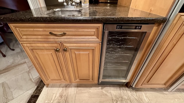 bar featuring wine cooler, sink, and dark stone counters