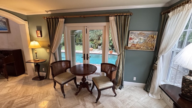 living area featuring crown molding and french doors