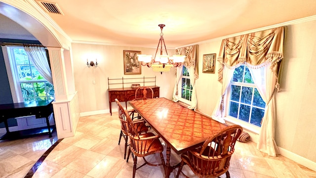 dining area featuring crown molding and a chandelier