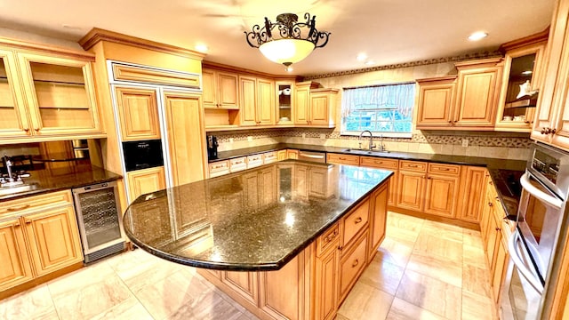 kitchen with a center island, backsplash, sink, dark stone countertops, and beverage cooler