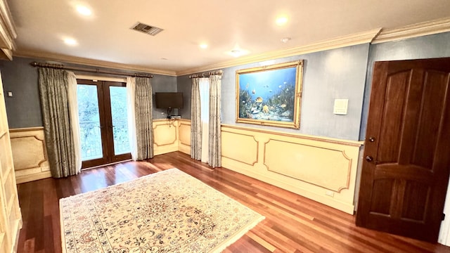 entrance foyer featuring french doors, ornamental molding, and dark wood-type flooring