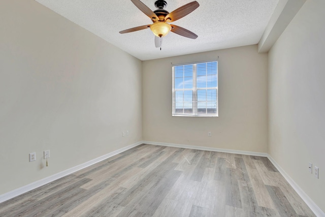 empty room featuring light hardwood / wood-style flooring, a textured ceiling, and ceiling fan