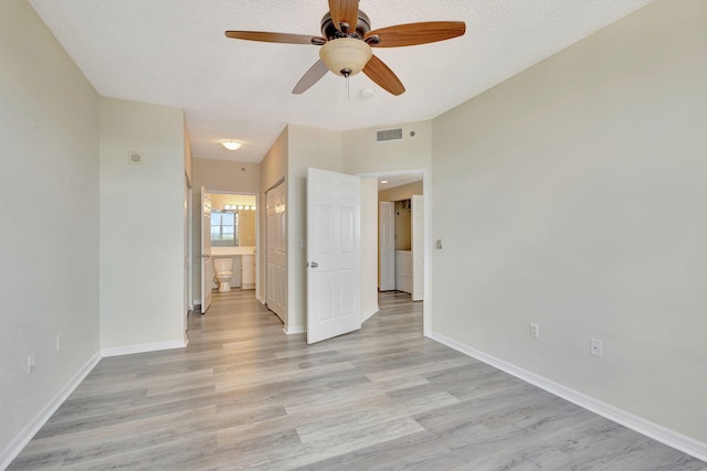 unfurnished room featuring light wood-type flooring, a textured ceiling, and ceiling fan