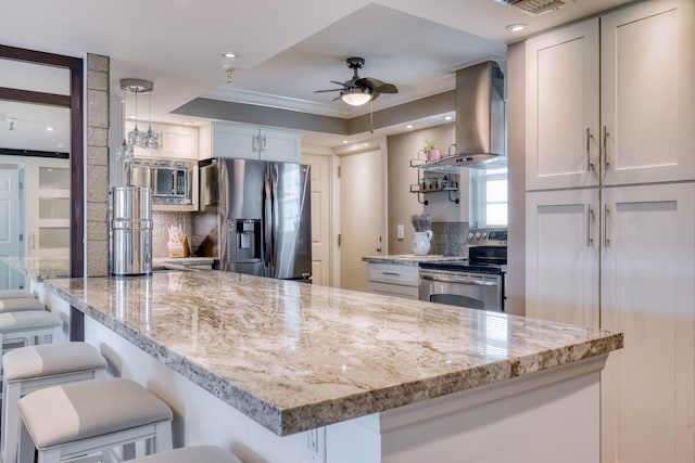 kitchen featuring white cabinetry, extractor fan, appliances with stainless steel finishes, and tasteful backsplash