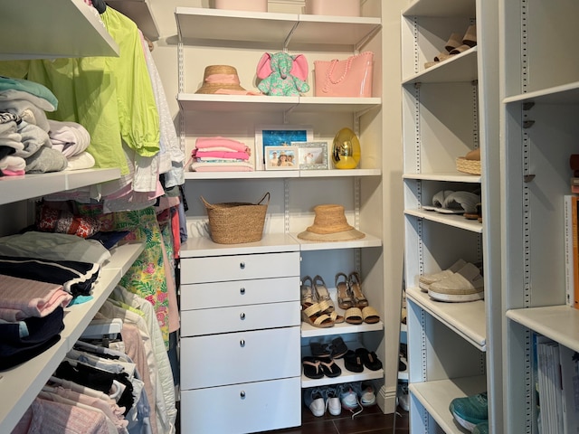 walk in closet featuring dark tile patterned floors