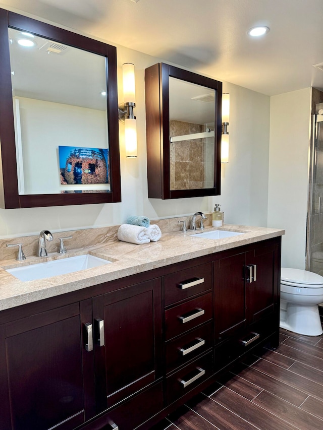 bathroom featuring vanity, walk in shower, toilet, and hardwood / wood-style flooring