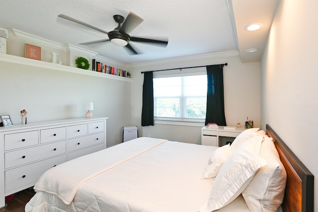 bedroom with crown molding, dark hardwood / wood-style floors, and ceiling fan