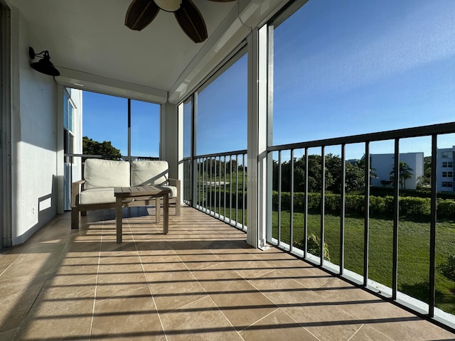 unfurnished sunroom featuring ceiling fan