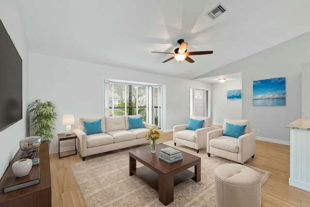 living room featuring ceiling fan, light hardwood / wood-style flooring, and vaulted ceiling