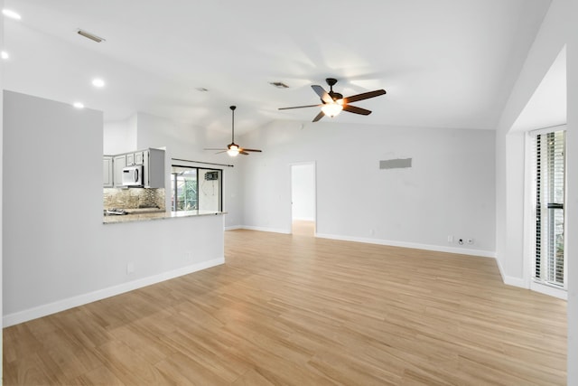 unfurnished living room featuring light wood-type flooring, ceiling fan, and lofted ceiling