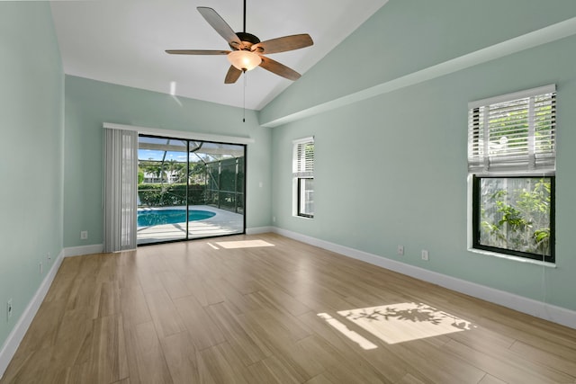 unfurnished room featuring ceiling fan, high vaulted ceiling, and light hardwood / wood-style flooring