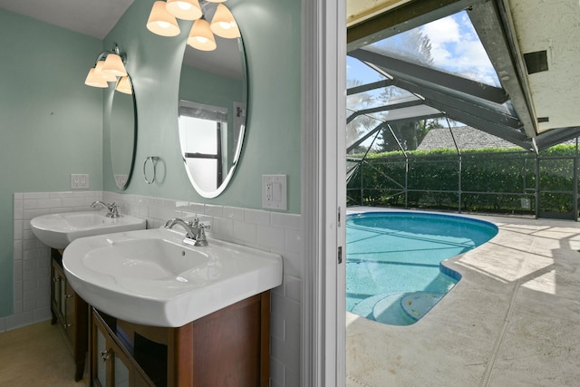 view of pool featuring a lanai and sink