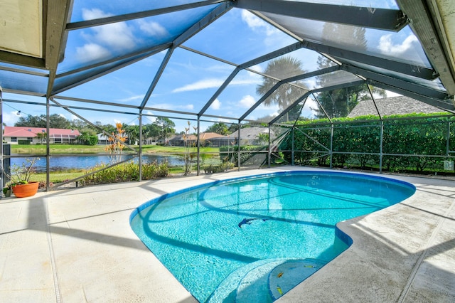 view of swimming pool featuring a lanai, a patio area, and a water view