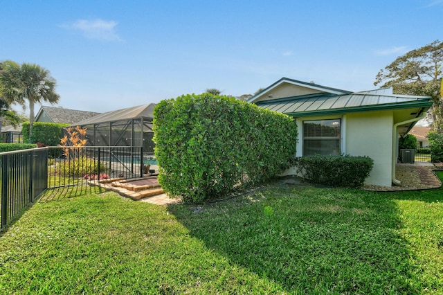 view of yard with a lanai and a fenced in pool