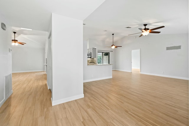 unfurnished living room with light hardwood / wood-style floors and lofted ceiling