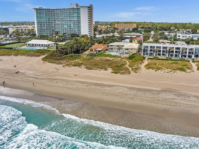 bird's eye view with a water view and a beach view