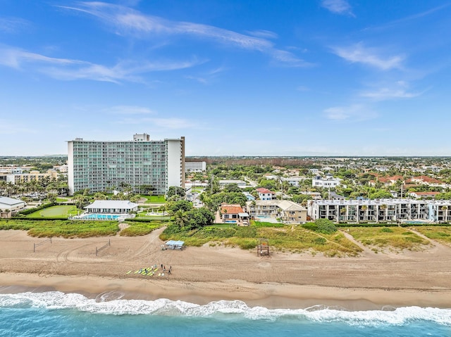 birds eye view of property featuring a beach view and a water view